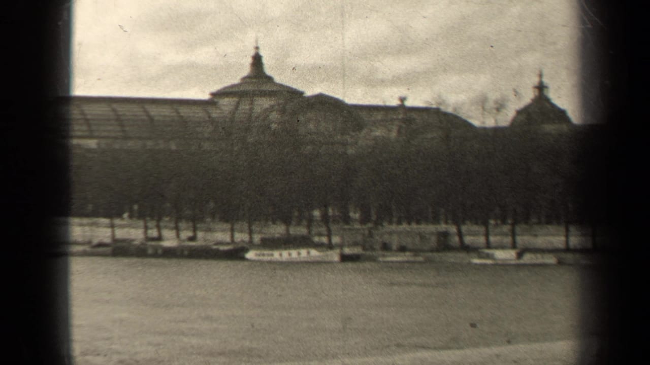 1947 Paris frame showing river water, a line of trees and moored boats beneath a large classical-looking building.