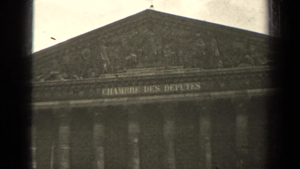 1947 Paris 8mm frame showing the upper facade of the Chambre des Députés with inscription, columns, and dark film edges.