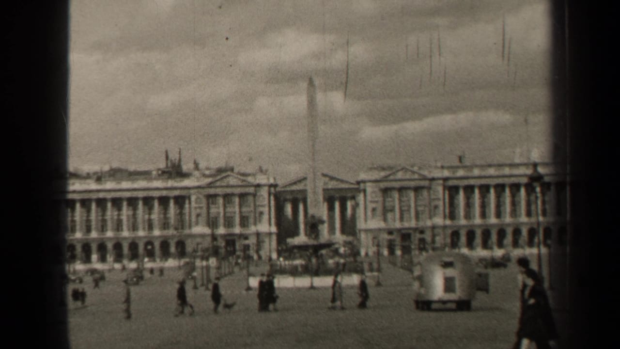 1947 Paris square with a tall obelisk, scattered pedestrians, passing cars, lampposts, and grand neoclassical facades.