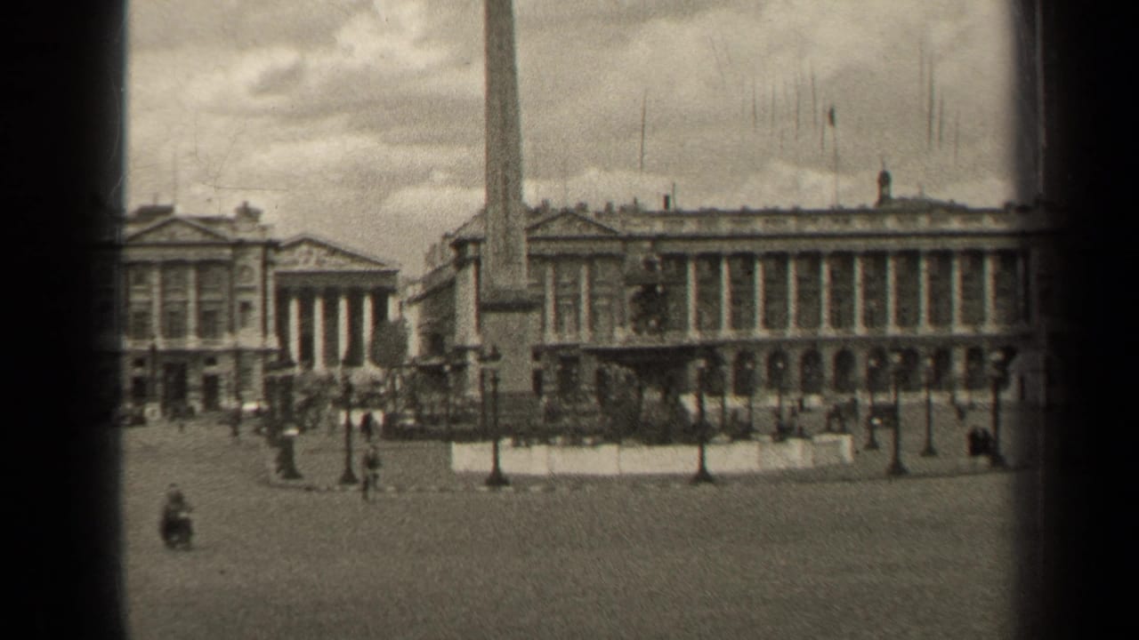 Black-and-white 8mm frame of a Paris public square in 1947, showing the obelisk, formal architecture, and distant people crossing the paving.