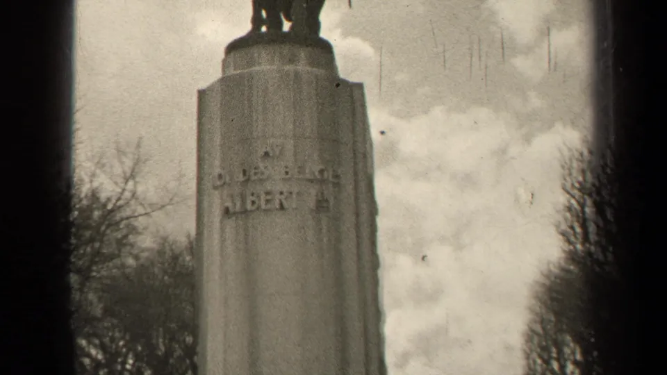Black-and-white Paris frame showing the upper pedestal of an equestrian monument with partial raised inscription visible.