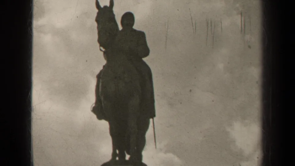 1947 Paris 8mm frame showing a closer upward view of the Albert I equestrian statue against clouds.