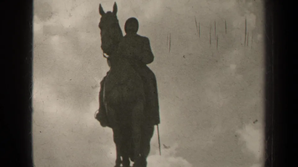 1947 Paris 8mm frame showing a dark equestrian statue silhouette with the rider and horse set against a cloudy sky.