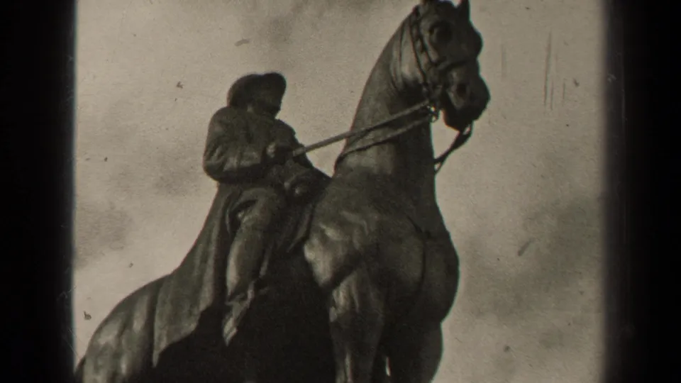 1947 Paris frame showing a close, soft-focused view of the mounted rider statue and horse against gray clouds.