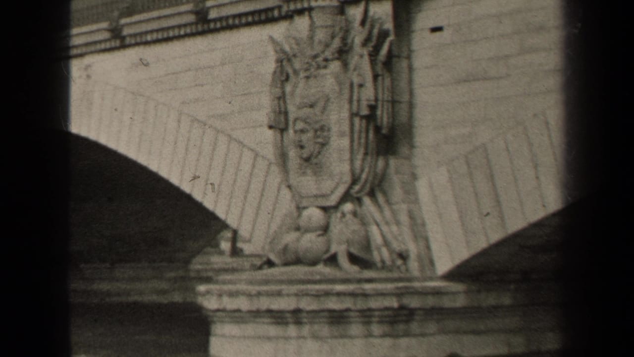 Stone bridge arches and a sculpted figure above a flowing river.