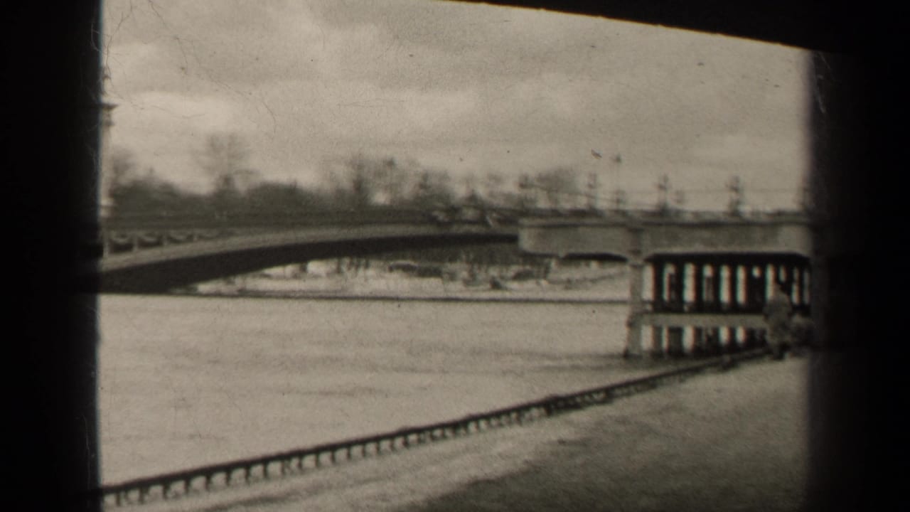 1947 Paris frame with the bridge spanning the river, decorative posts along the deck, and structural supports near the right edge.