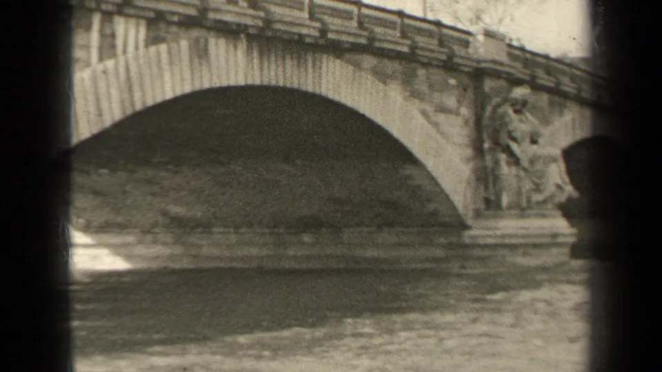 1947 Paris 8mm frame showing a broad stone bridge arch and river water below, with dark contact-sheet borders.
