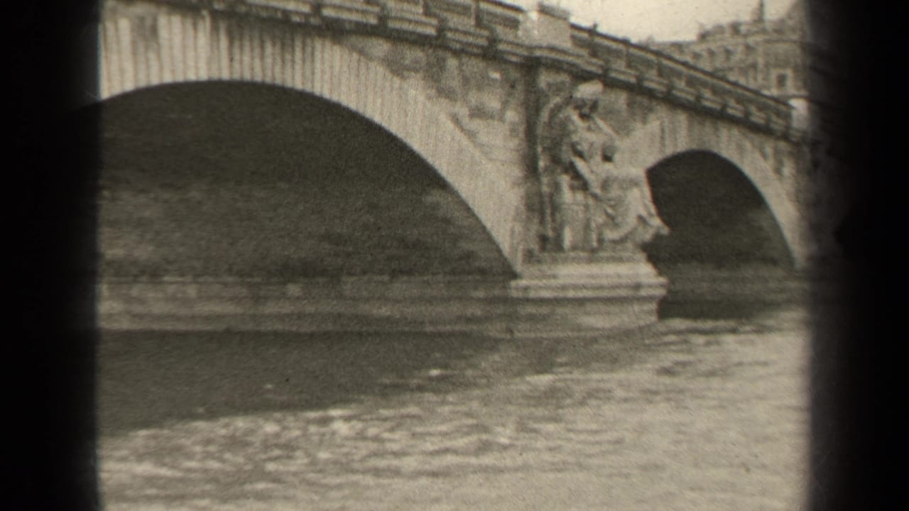 1947 Paris frame with ornate stone bridge piers, multiple arches, and gently moving river water.