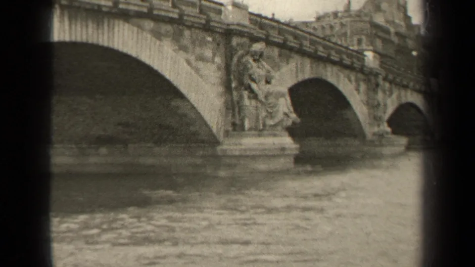 Black-and-white 1947 Paris 8mm view of a historic stone bridge with sculpted pier details over the river.