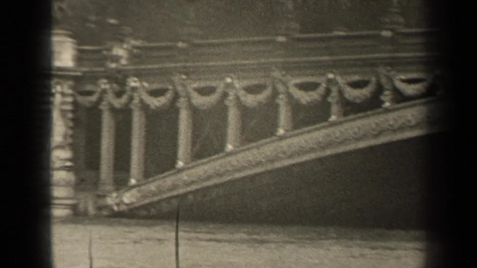 1947 Paris frame showing a decorative bridge balustrade and sloping span with soft grain and dark film borders.