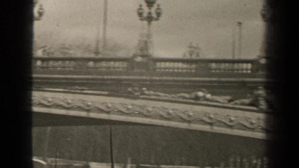 A 1947 Paris bridge view with balustrade, lampposts, carved stonework, and heavy vertical contact-sheet borders.