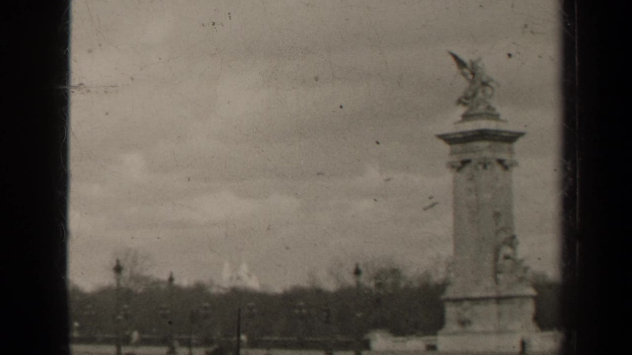 1947 Paris frame of a Pont Alexandre III statue and pylon, with embankment trees and small distant figures near the Seine.