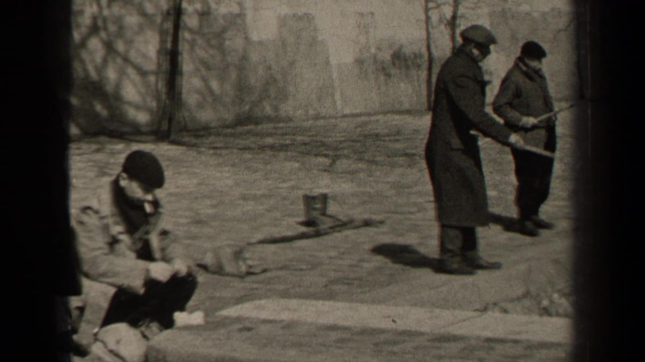 A 1947 Paris frame shows a man in a beret seated on the pavement, smoking and looking down, with two men standing nearby.