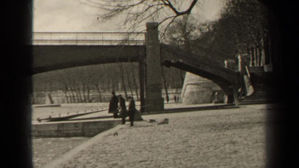 The 1947 Paris footage looks across a riverside bridge scene, with pedestrians under bare trees near steps and the waterline.