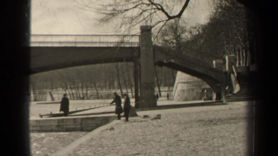 Near the end of the 1947 Paris clip, pedestrians remain on the embankment below the bridge beside the water.