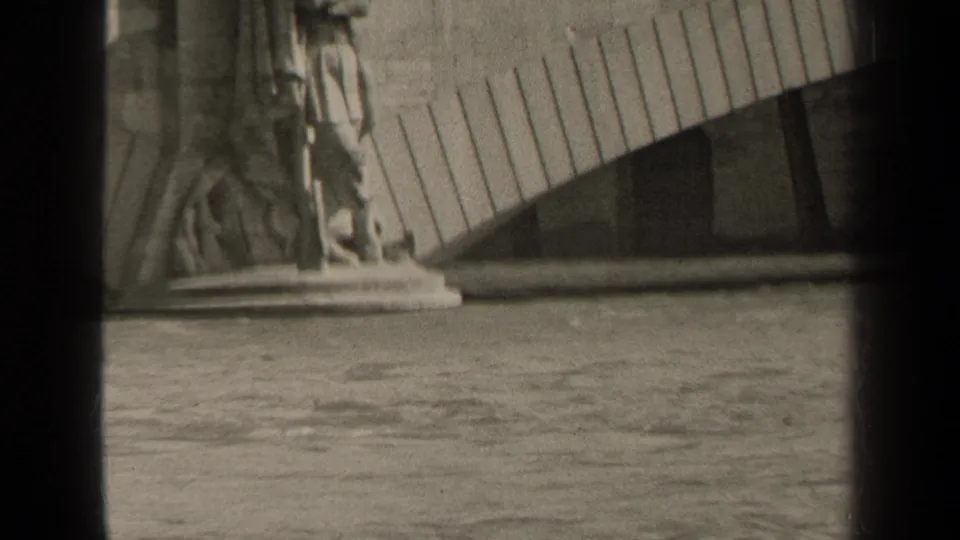 1947 Paris 8mm frame with a partial carved figure, stone base, water below, and visible film-gate edges.