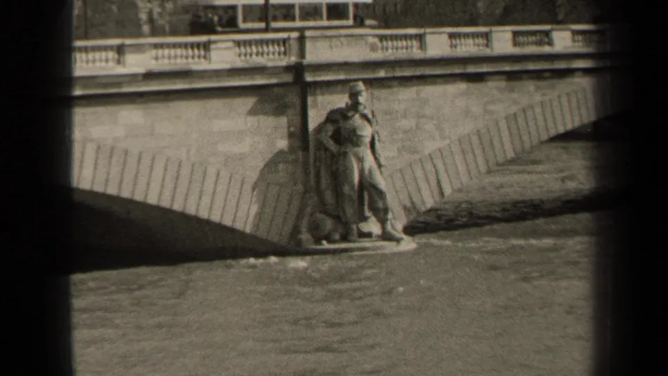 1947 Paris 8mm frame with a statue near the bridge pier, balustrade above, and floodlike water visible below.