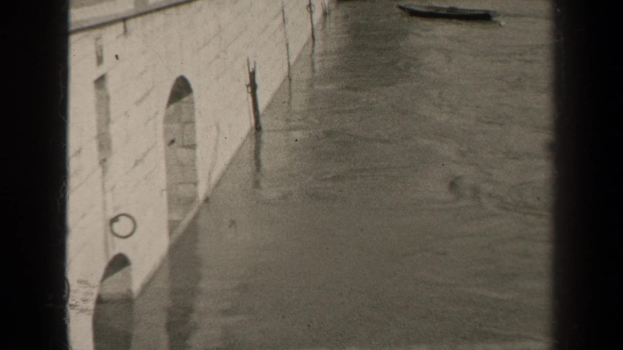 A second 1947 Paris view shows floodwater along a pale stone embankment, with small boats near the top of the frame and heavy film borders.