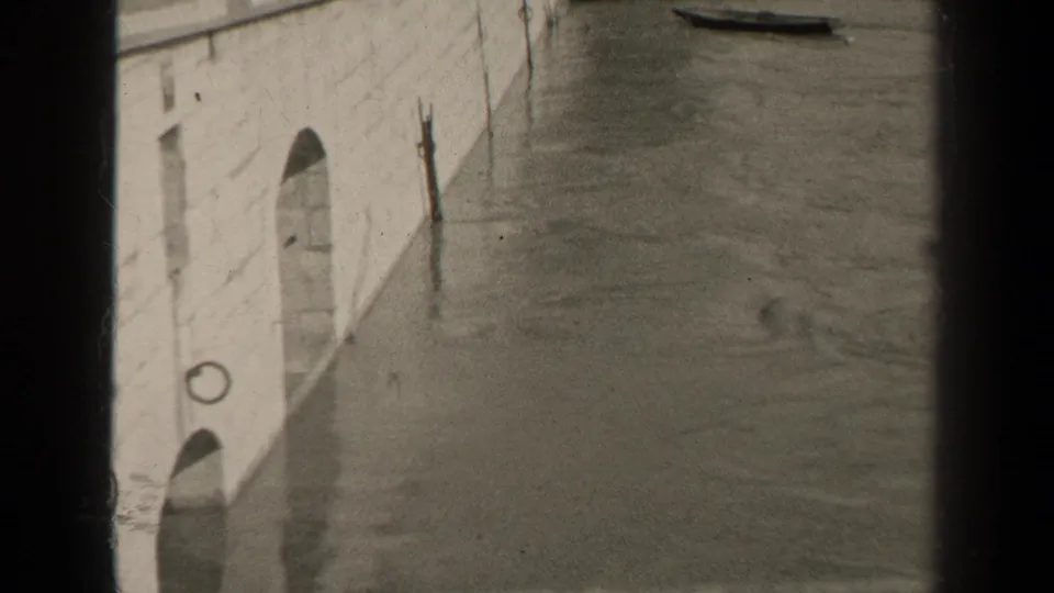 A second 1947 Paris view shows floodwater along a pale stone embankment, with small boats near the top of the frame and heavy film borders.