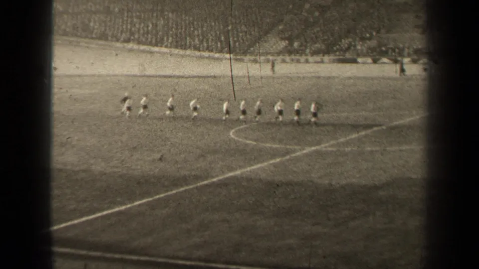 1947 Paris football match footage shows players lined up near the center circle before play, with spectators beyond the pitch.