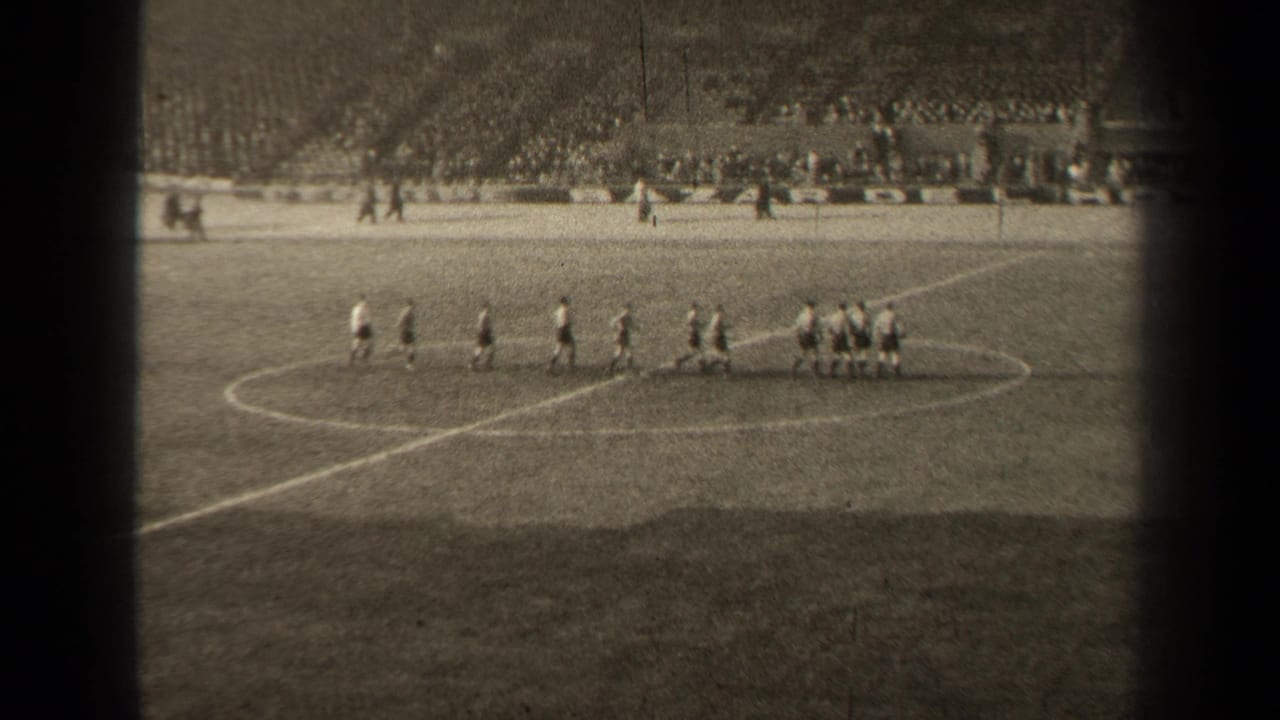 1947 Paris soccer footage showing two groups of players near midfield with a stadium crowd beyond the grass pitch.
