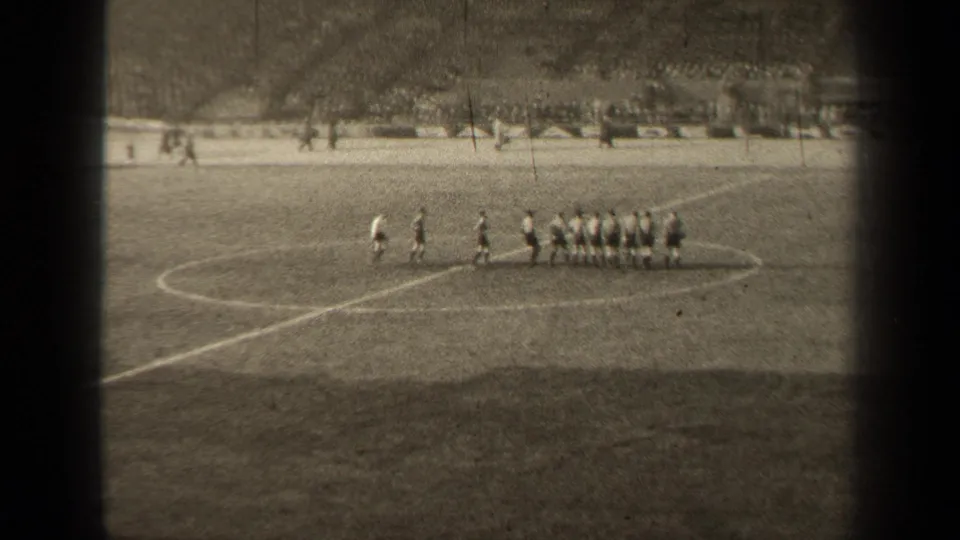 1947 Paris soccer match scene with players lined up across the center circle and spectators visible behind the field.