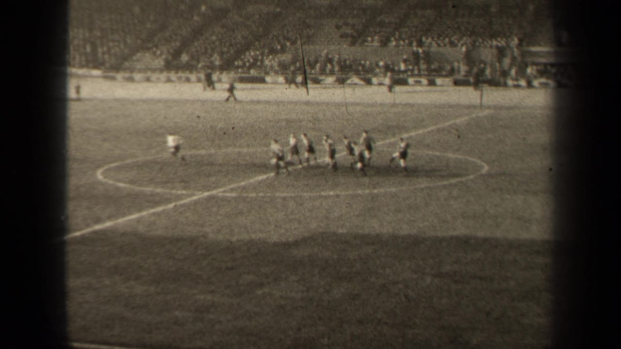1947 Paris football match view from the stands, with players grouped near midfield and a crowd visible beyond the pitch.