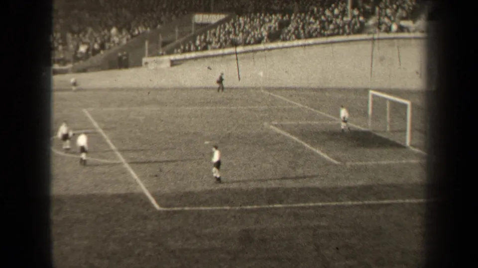 A goalmouth sequence in the 1947 Paris soccer footage shows players closing in near the ball while a goalkeeper stands by the goal.