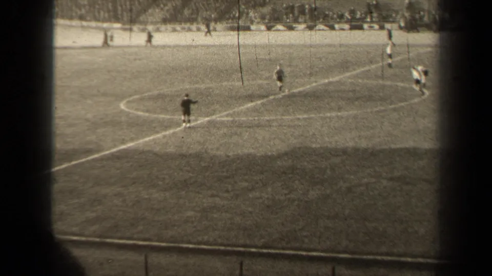 1947 Paris 8mm view of a soccer match, with a dark-clad figure near the center circle and players clustered along the right side.