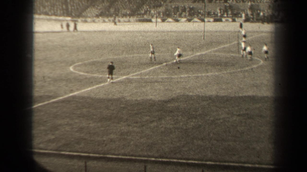 1947 Paris football match viewed from the stands, with players in light and dark uniforms spread near the center circle.