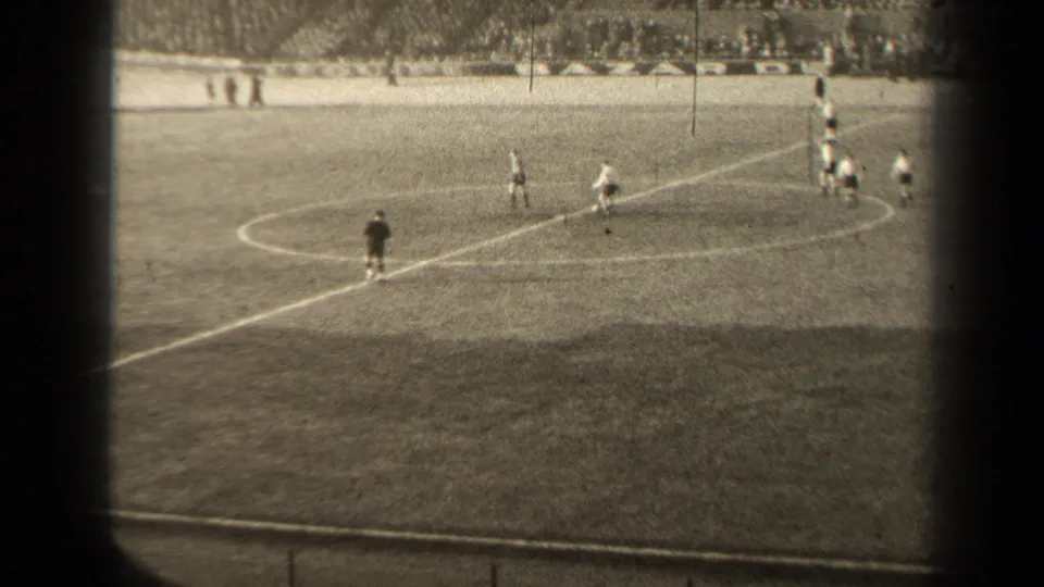 1947 Paris football match viewed from the stands, with players in light and dark uniforms spread near the center circle.