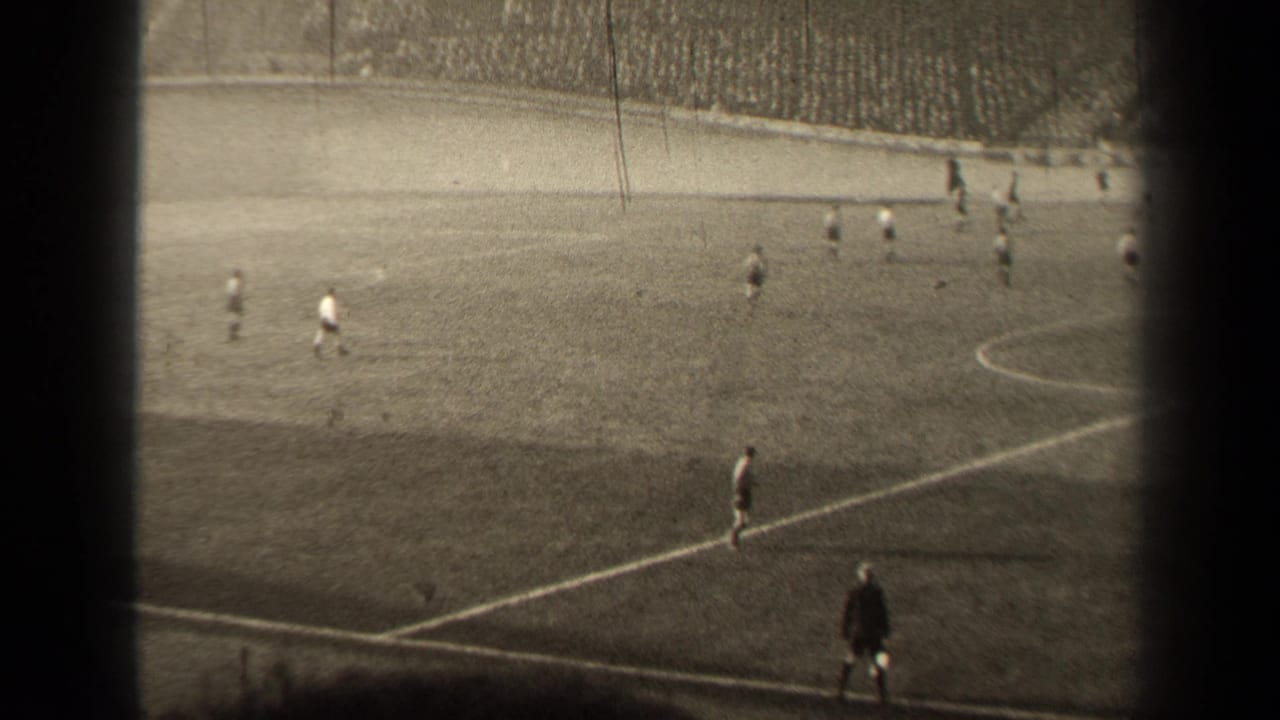 1947 Paris soccer match viewed from high in the stands, with players spread across the pitch and a crowd beyond the field.