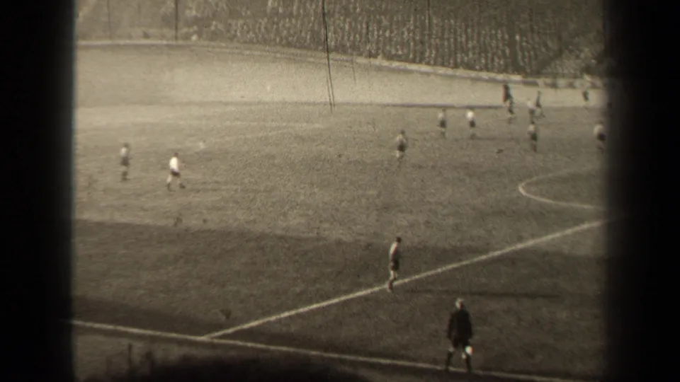 1947 Paris soccer match viewed from high in the stands, with players spread across the pitch and a crowd beyond the field.