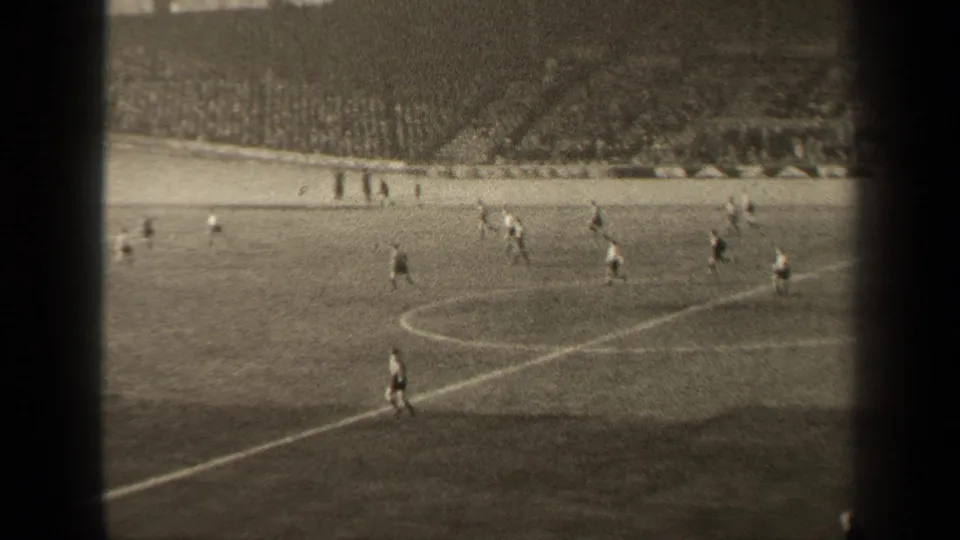 Paris soccer match footage from 1947 with players dispersed across the pitch and spectators filling the far stands.