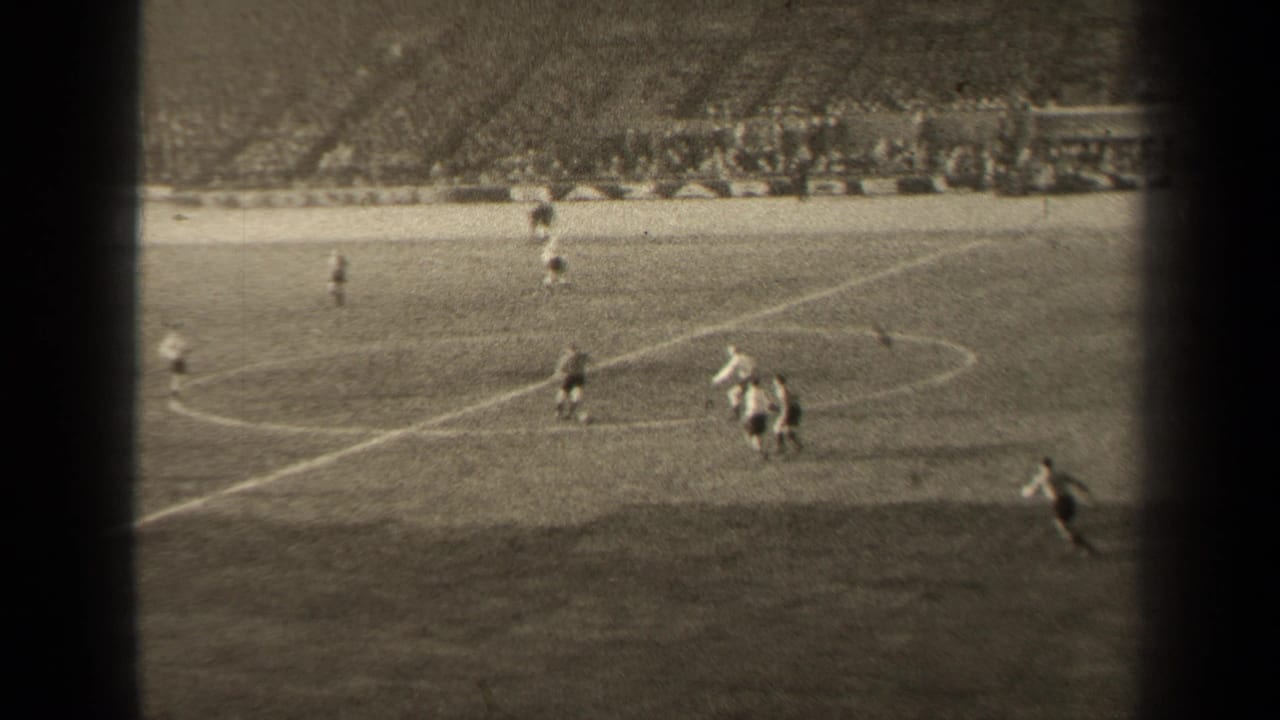 1947 Paris soccer match viewed from above, with players spread across the pitch and spectators filling the background stands.