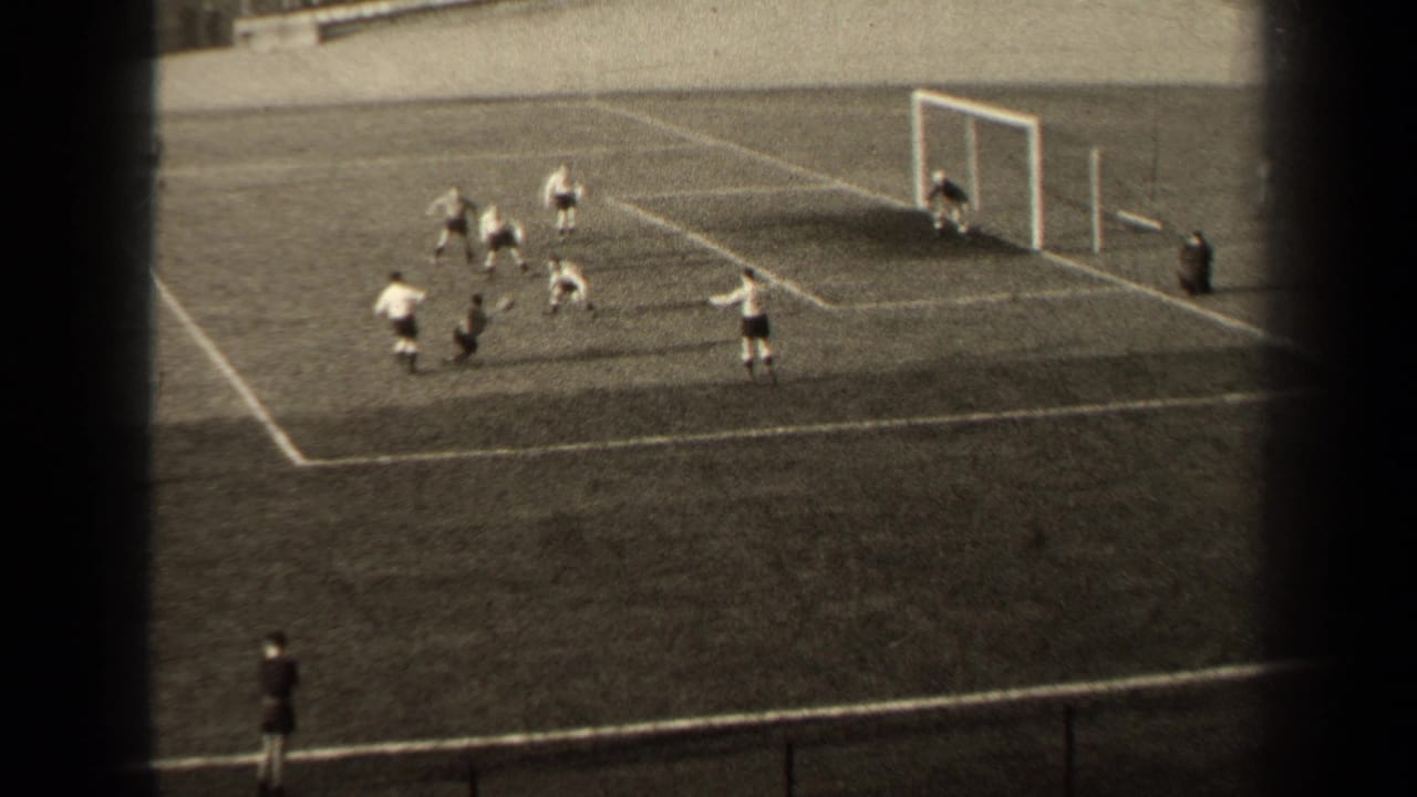 1947 Paris football action near the goal mouth, with several players in light and dark kits clustered inside the penalty area.