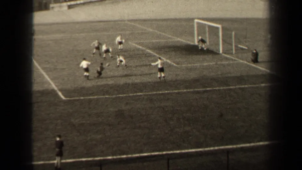 1947 Paris football action near the goal mouth, with several players in light and dark kits clustered inside the penalty area.