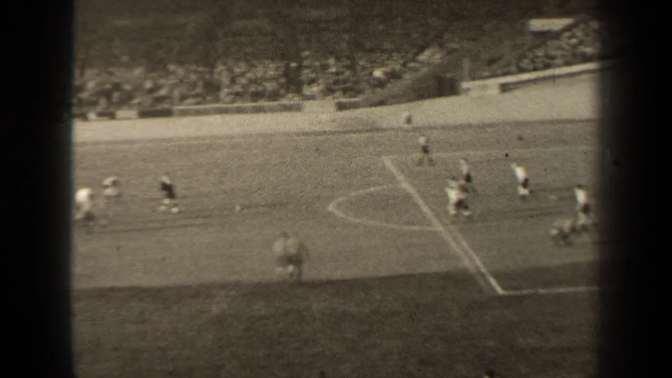 1947 Paris football match from a raised stand position, showing players moving across the pitch with spectators in the background.