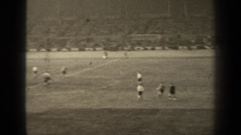 The closing frame shows the 1947 Paris soccer match from a fixed spectator viewpoint, with players dispersed across the pitch and stands in back.