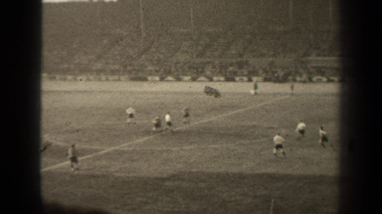 1947 Paris soccer match seen from a high spectator viewpoint, with players on the pitch and a large crowd beyond the field.