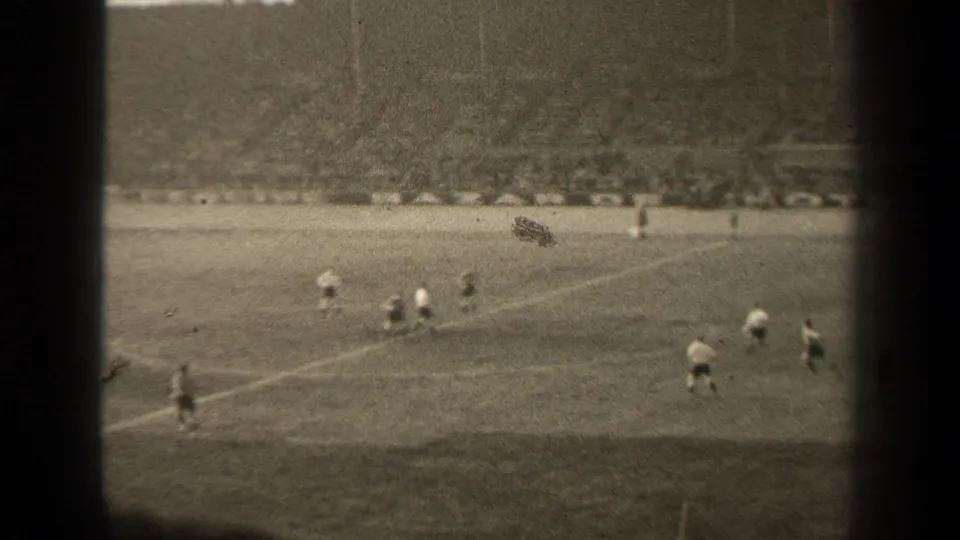 1947 Paris soccer match seen from a high spectator viewpoint, with players on the pitch and a large crowd beyond the field.