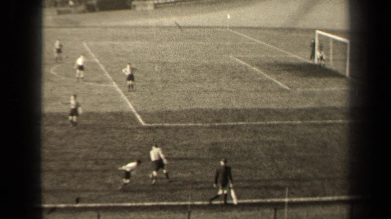 1947 Paris soccer match frame with players near the touchline, a goal at right, and pitch markings visible across the field.
