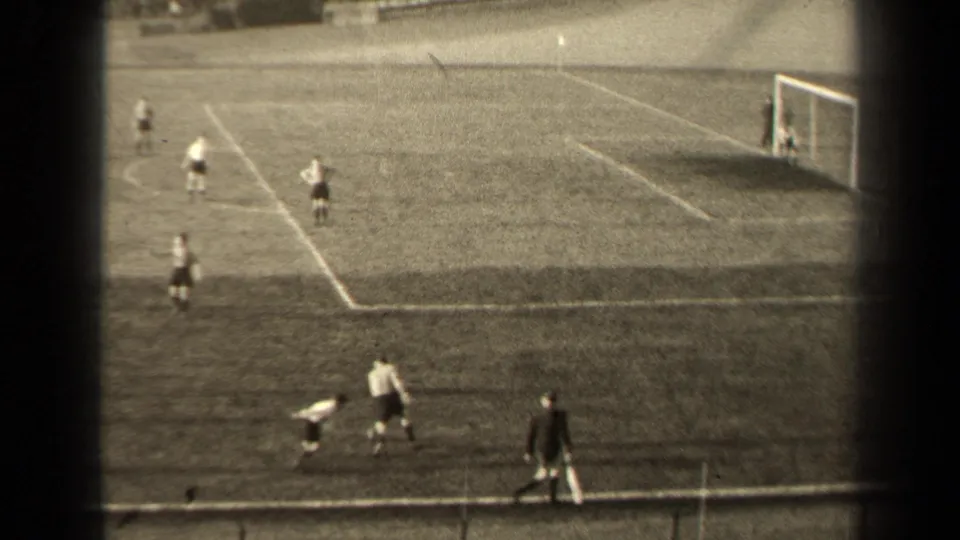 1947 Paris soccer match frame with players near the touchline, a goal at right, and pitch markings visible across the field.