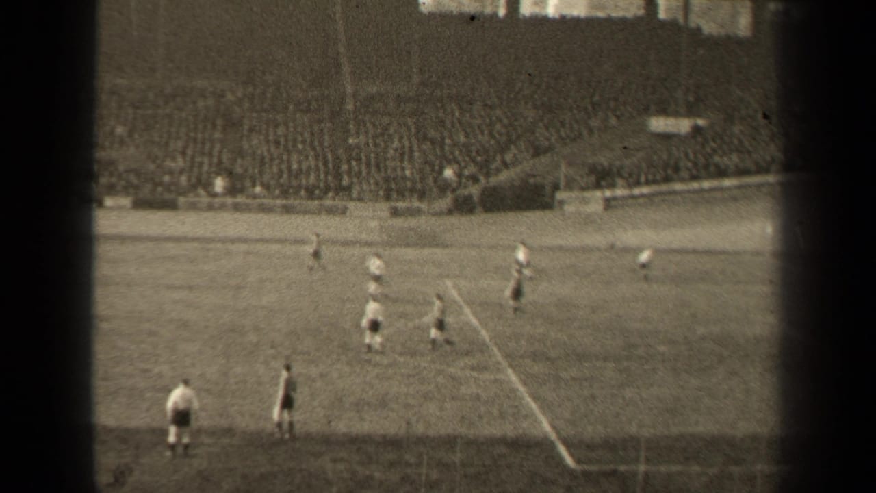 1947 Paris soccer match seen from a distant 8mm spectator angle, with players on the pitch and crowded stands in the background.