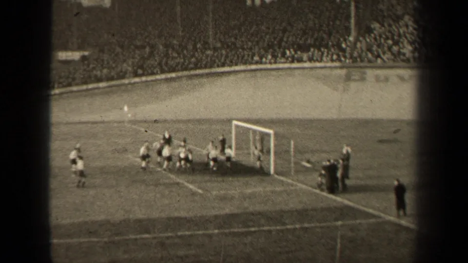 A crowded 1947 Paris football goalmouth scene shows players packed near the net, filmed from a distant spectator angle on 8mm.