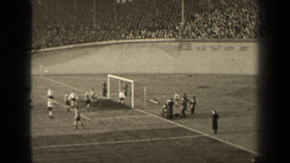 The final frame shows players moving away from the goal in a crowded Paris stadium, with sideline figures and visible 8mm frame borders.