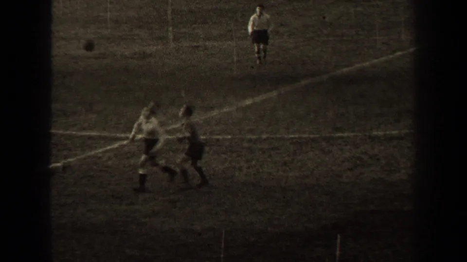 1947 Paris soccer footage showing players in light shirts and dark shorts moving near field markings on a grass pitch.