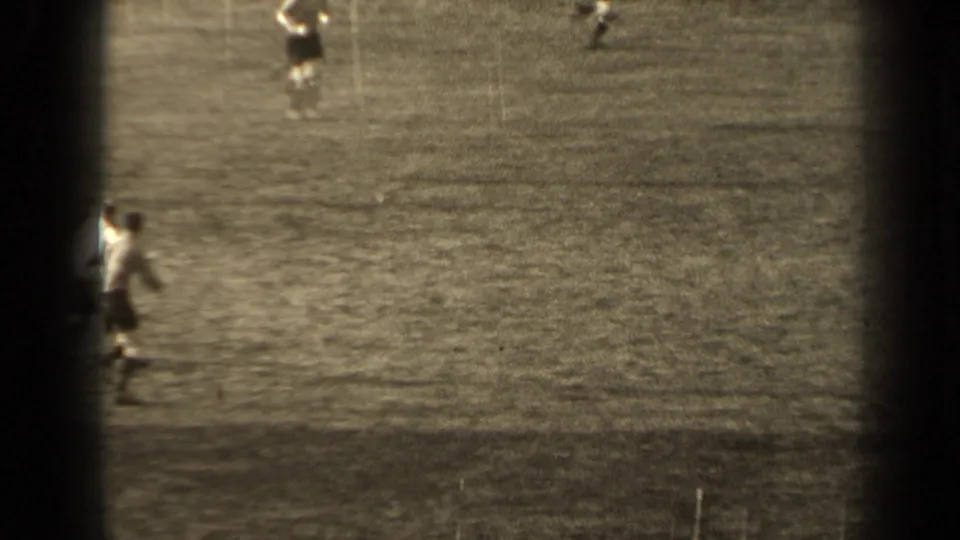 A cropped 1947 Paris soccer frame showing players partly at the edge of the 8mm home-movie view.