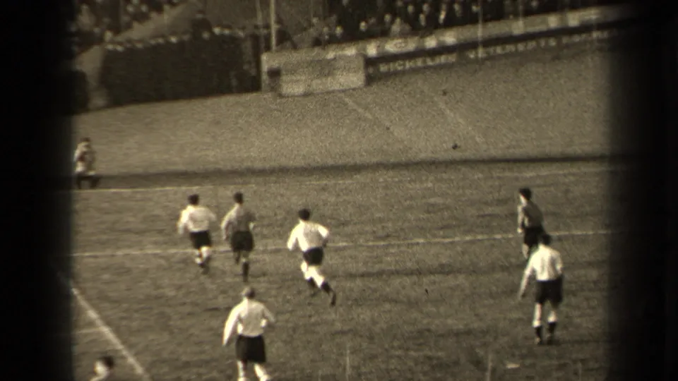 A wide 1947 Paris soccer view shows players spreading across the pitch, with spectators and possible advertising signage behind the touchline.