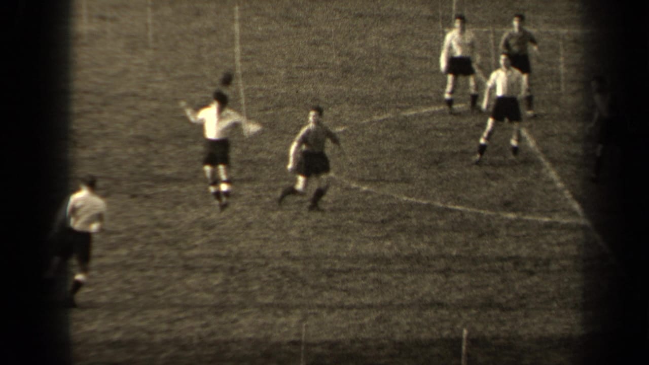 Players spread across the field as one raises his arms and others watch the ball.